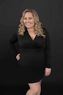 happy portrait client wearing a black dress and smiling