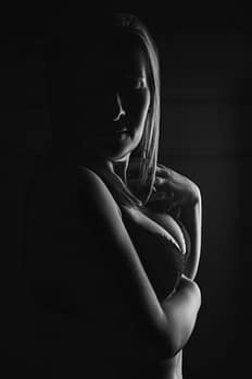 woman-heavily-shadowed-hugging-herself-boudoir-portrait-Amy Paris Photography, Munster, IN